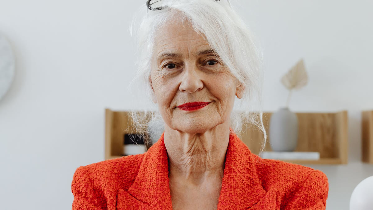 An older woman working confidently at a laptop, representing renewed ambition and drive after testosterone restoration.